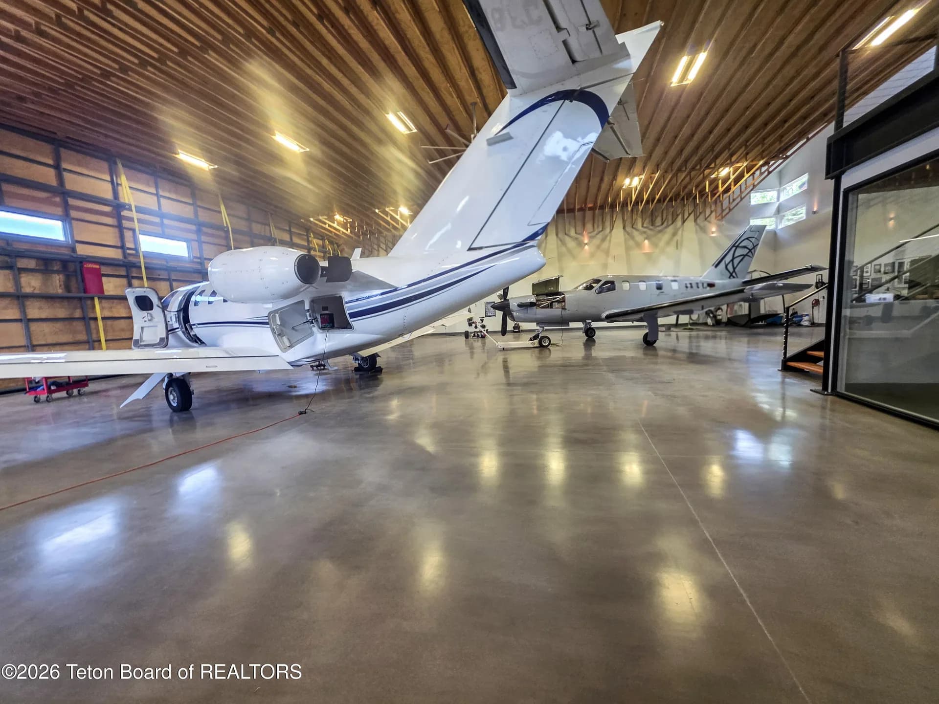 Aircraft positioned inside the large private hangar at 872 Alpine Village Loop
